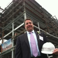 <p>Christopher Riendeau, senior vice president of fund development, stands in front of the new Stamford Hospital. The hospital celebrated a major milestone in its construction by having a &quot;topping off&quot; event. The new hospital will be ready by mid-2016.</p>