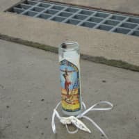 <p>A candle was left on the sidewalk on Leonard Street where the 43 year-old Norwalk man was found shot to death early Thursday morning.</p>
