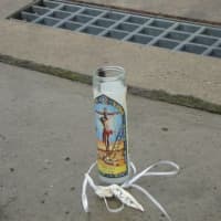 <p>A candle was left on the sidewalk on Leonard Street where the 43 year-old Norwalk man was found shot to death early Thursday morning. </p>