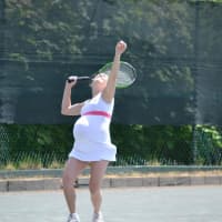 <p>She serves the ball to her opponent. </p>