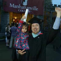 <p>A Manhattanville College graduate student celebrates the conferment of his degree. </p>