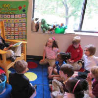 <p>Chapel School third-grader Charlie and &quot;Principal for a Day&quot; reads to classmates.</p>