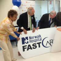 <p>Fairfield First Selectman Michael Tetreau with Arlene Putterman, Community Relations Manager for Stop &amp; Shop; Dr. Michael Marks of Norwalk Hospital and Brad Dayton of Ahold rip off the bandaid to open the new Fast Care Clinic in Fairfield.</p>