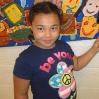 <p>A third-grade student from Highview Elementary School in Greenburgh shows her mural. </p>