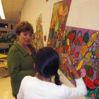<p>Miriam Bernabei, director of Aats, music and special programs in the Greenburgh Central School District, talks with a student. </p>