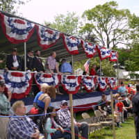 <p>Local dignitaries on the main stage at the end of the parade greet the marchers at the end of a long walk. </p>