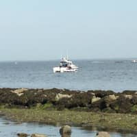 <p>First responders search the waters of Long Island Sound off Norwalk for a missing boater on Monday. </p>