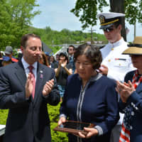 <p>Applause are given during the dedication of the Route 120 bridge in honor of Staff Sgt. Kyu H. Chay.</p>
