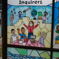 <p>One of the stained-glass panels in the Jackson School depicting one of the educational attributes &quot;Inquirers&quot;.</p>
