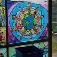 <p>Stained-glass panels in the Jackson School depicting another of the educational attributes -- &quot;Open-Minded&quot;.</p>