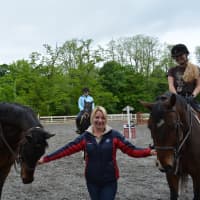<p>Ashley Yozzo poses for a photo with horses at Summit Farm in North Salem.</p>