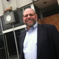 <p>Time to get started. Kenneth Olson, president and CEO of developer POKO Partners, stands outside a former Wall Street bank. Olson and other officials announced demolition and site remediation will begin soon and a new development ready in 30 months.</p>