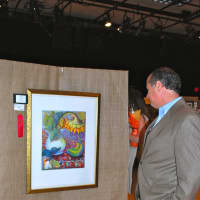 <p>Darien resident Bob Marchesi views artwork at the 2013 Darien Art Show and Sale.</p>