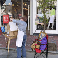 <p>Artist Gini Fischer of Wilton prepares her easel to paint a portrait of her daughter at  Westport&#x27;s annual Art About Town.</p>