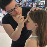 <p>Here, 7-year-old Charlotte Lewis gets her face painted at the annual Westport Art About Town festival. </p>