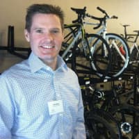 <p>Peter Woods, president and CEO of Dorel Recreational/Leisure, stands by Cannondale Sports Unlimited employee bicycles. The company held the grand opening for its new Wilton headquarters on Friday.</p>