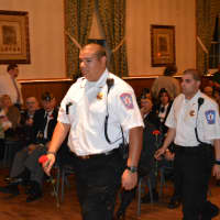 <p>Members of the Mount Kisco Volunteer Ambulance Corps walk with flowers for the Memorial Day service.</p>