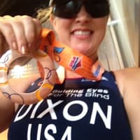 <p>Amy Dixon proudly displays her bronze medal after finishing third Sunday in her division of the Pan American Triathlon Confederation paratriathlon championships.</p>