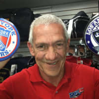 <p>Skate Zone Pro Shop employee George Comesana holds up souvenir hockey pucks with the New York Rangers and Los Angeles Kings logs on them. He hopes the Rangers win but said he&#x27;d be happy with a Kings victory because he knows LA goalie Jonathan Quick.</p>