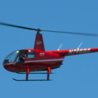 <p>A zoomed version of a photo that shows a red helicopter flying over downtown Armonk.The helicopter&#x27;s tail number is visible.</p>