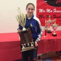 <p>Sylvie Binder (14) holds the first place award for winning the 2014 Womens Senior Open Foil competition at the Mr. Ma Cup. </p>
