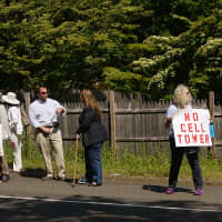 <p>Dozens of people gather at the side of Greens Farms Road in Westport on Tuesday to fight a proposed cellphone tower. </p>