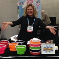 <p>Allison Brush-Stern shows off her CollapseAPail product at the NYC Toy Fair.</p>