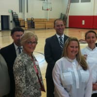 <p>Companies that sponsor programs at the newly reopened J.M. Wright Technical School get a tour Tuesday. From left in the gym are: Tom Regan, Raymond Mencio, Judy Resnick, Dan Smith, Laura Varrone, Meredith Keiling and Pat Ciarleglio.</p>