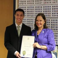 <p>Wilton High senior Chase Smith accepts his award from Secretary of the State Denise Merrill.</p>