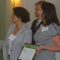 <p>Lu Munk (left), farm director, and Helen Brady (right) accept the Land Use award on behalf of Hilltop Hanover Farms. </p>