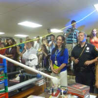 <p>Students and teachers nervously watch the Rube Goldberg machine to see if it works. </p>