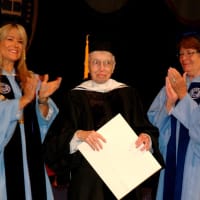 <p>Sister Alice Gallin, center, is presented with an honorary degree from the College of New Rochelle.</p>