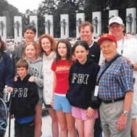 <p>Leah Murphy, left, and her dad, John P. Lennon, front right,  anchor this picture taken at the World War II Monument in Washington, D.C, in 2004. </p>