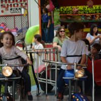 <p>4-year-old Gabrielle Peck spends time on a ride at the Fol de Rol.</p>
