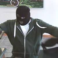 <p>The suspect who robbed the TD Bank on the Post Road in Fairfield displays a dark-colored semi-automatic pistol, police said.</p>