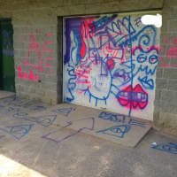 <p>Spray painted damage on the Zinsser Field wall.</p>