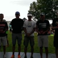 <p>Chris Thomas, left, stands on the podium after winning the Eagleman triathlon Sunday in Maryland. </p>