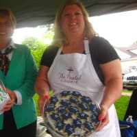 <p>Nancy Saxe of Sweet Pierre&#x27;s and Susan Schmitt of the Painted Cookie offer some of their sweets to the attendees of a Taste of Wilton on Monday.</p>