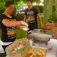 <p>Amanda Bogdanowicz of Bistro 7 hands out samples at a Taste of Wilton.</p>