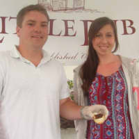 <p>Lars Anderson and Natalie Riecker of the Little Pub in Wilton give people a taste of bacon jam.</p>