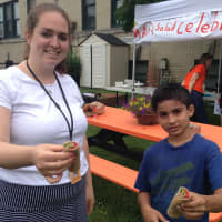 <p>Christine Luciano and one of her students Kobe Sekhatme made salad wraps out of the herb plants they grew in the Mamaroneck Avenue School community garden. </p>