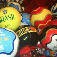 <p>Soccer balls with the names of World Cup countries and of course Barcelona and Manchester United in a bin at Soccer &amp; Rugby Imports at 42 W. Putnam Ave.</p>