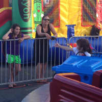 <p>Jackie Mannix reaches out for her mom, Fran, as she goes round-and-round on a ride, along with Sofia Butini (right) at St. Vito&#x27;s Festa Thursday. </p>