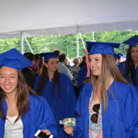 <p>Members of the Class of 2014 enter the tent for graduation</p>
