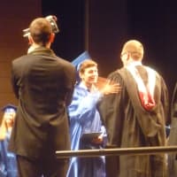 <p>A student receives his diploma at the Byram Hills graduation. </p>