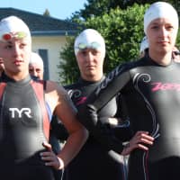 <p>Swimmers listen to pre-event instructions.</p>
