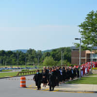 <p>Somers officials and Class of 2014 members march from the high school to the graduation tent.</p>