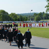 <p>Somers officials and Class of 2014 members march from the high school to the graduation tent.</p>