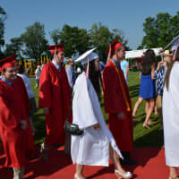 <p>Somers High School Class of 2014 members walk on a red carpet to their graduation.</p>