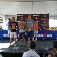 <p>Chris Thomas, left, stands on the podium with other award winners after Sunday&#x27;s race in Syracuse. </p>